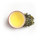 Tea cup with green tea leaves
