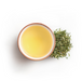 Tea leaves and a cup of tea on a white background